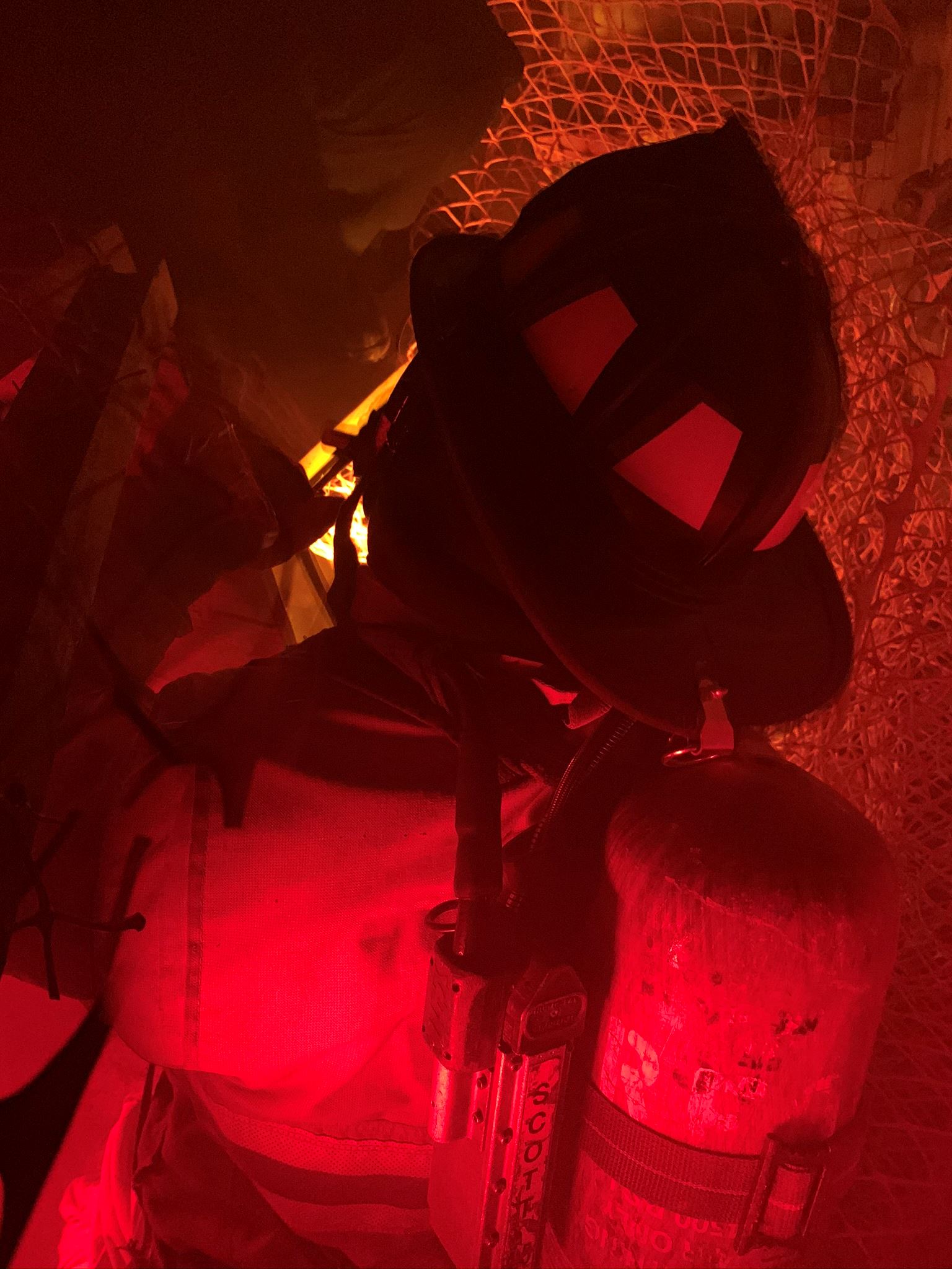 Picture of a firefighter in red lighting